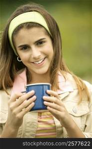 Portrait of a girl holding a mug