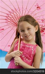 Portrait of a girl holding a parasol and smiling