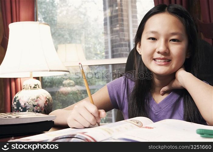 Portrait of a girl holding a pencil