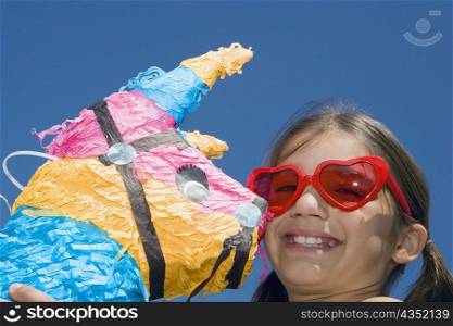 Portrait of a girl holding a rocking horse