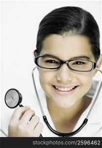 Portrait of a girl holding a stethoscope and smiling