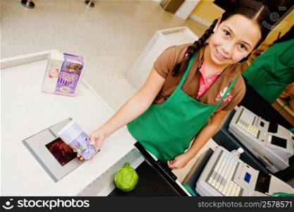 Portrait of a girl holding disposable cups at the checkout counter