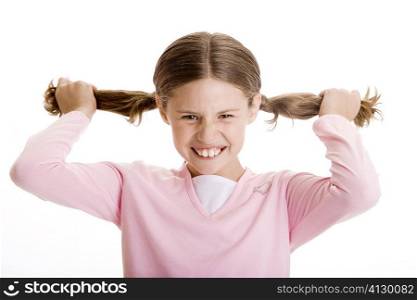 Portrait of a girl holding her pigtails