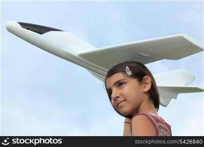 portrait of a girl holding model plane