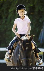 Portrait of a girl horseback riding
