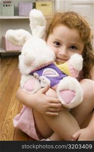 Portrait of a girl hugging a stuffed toy