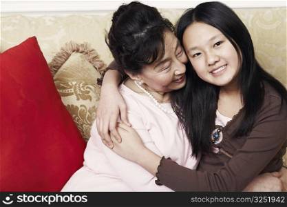 Portrait of a girl hugging her grandmother
