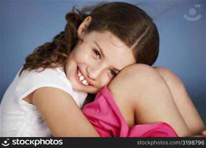 Portrait of a girl hugging her knees