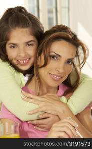 Portrait of a girl hugging her mother