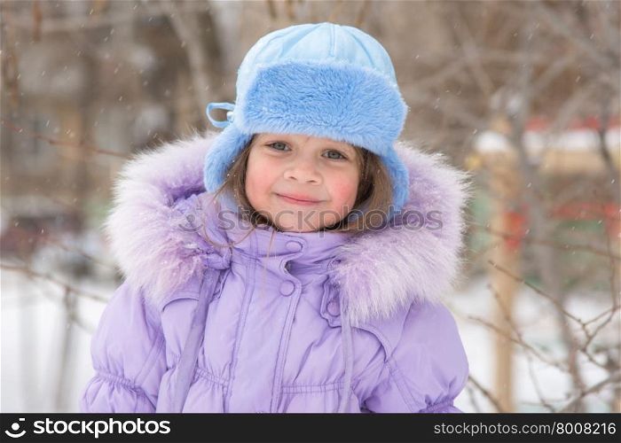 Portrait of a Girl in snowy winter weather. Portrait of a happy five year old girl in snowy winter weather