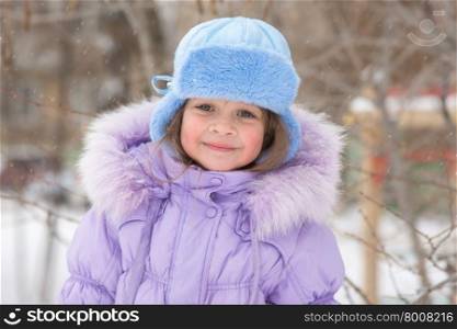Portrait of a Girl in snowy winter weather. Portrait of a happy five year old girl in snowy winter weather