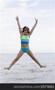 Portrait of a girl jumping on the beach