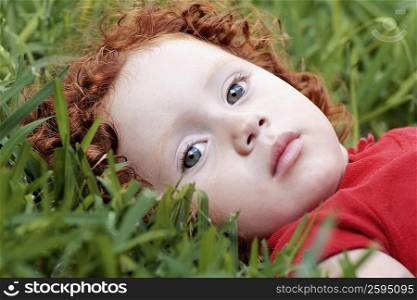 Portrait of a girl laying on the grass