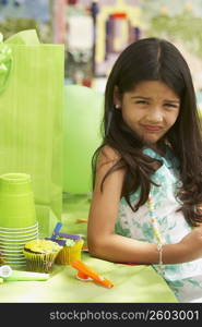 Portrait of a girl leaning against a table