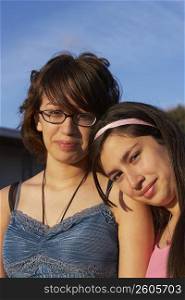 Portrait of a girl leaning on a teenage girl&acute;s shoulder