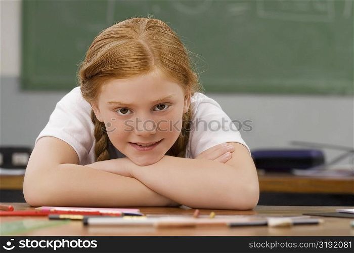 Portrait of a girl leaning on her elbows and smiling