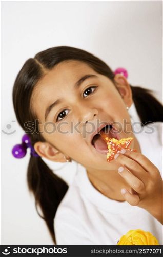 Portrait of a girl licking a candy