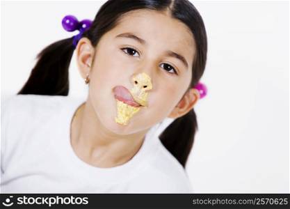Portrait of a girl licking cream on her face