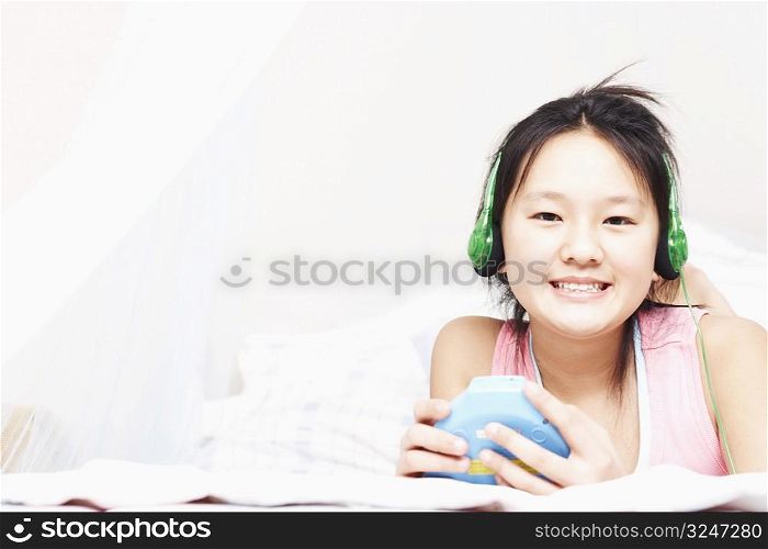 Portrait of a girl listening to music on an MP3 player
