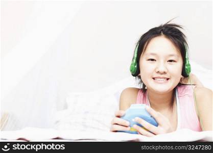 Portrait of a girl listening to music on an MP3 player