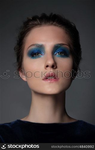Portrait of a girl model with blue makeup. Eyeshadow, Bright.