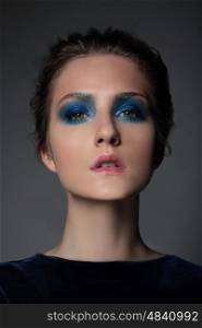Portrait of a girl model with blue makeup. Eyeshadow, Bright.