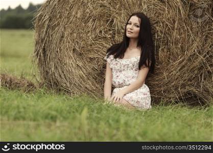portrait of a girl next to haystack