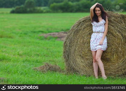 portrait of a girl next to haystack