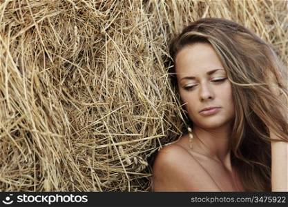 portrait of a girl next to haystack close