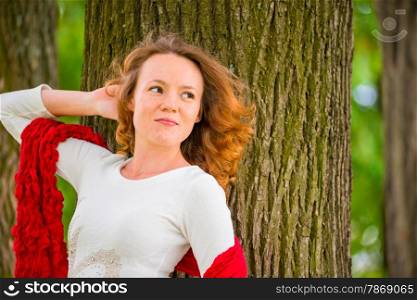 portrait of a girl on a background of a tree looking to the side