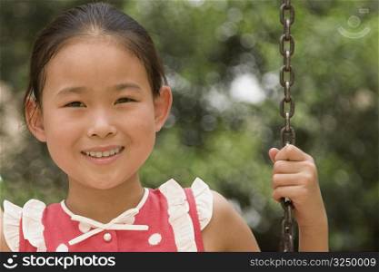 Portrait of a girl on a swing