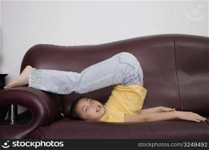 Portrait of a girl playing on a couch