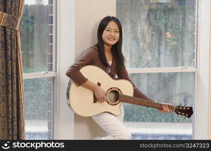 Portrait of a girl playing the guitar