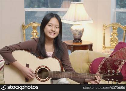 Portrait of a girl playing the guitar