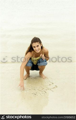 Portrait of a girl playing tic-tac-toe on the beach