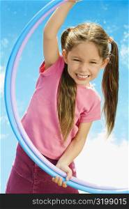 Portrait of a girl playing with two plastic hoops