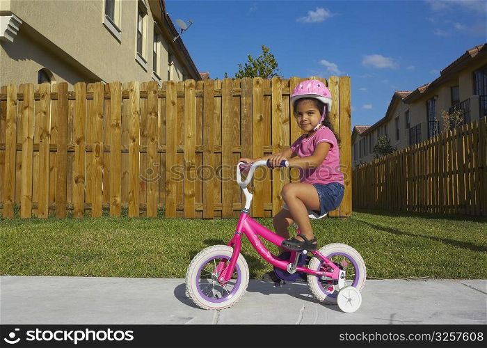 Portrait of a girl riding a bicycle on a path