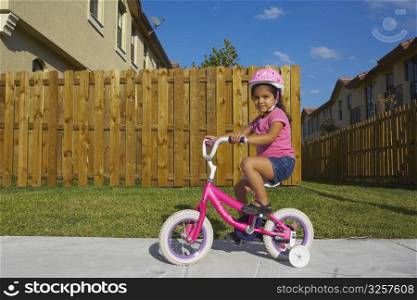 Portrait of a girl riding a bicycle on a path