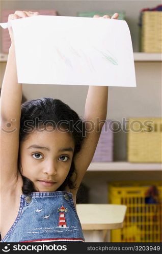Portrait of a girl showing a drawing