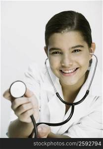 Portrait of a girl showing a stethoscope