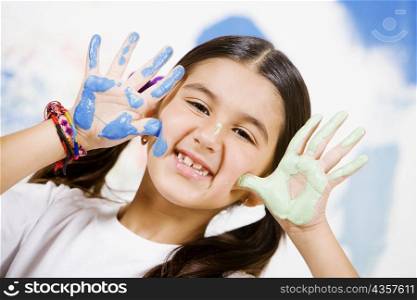 Portrait of a girl showing paint on her palms