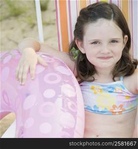 Portrait of a girl sitting in a folding chair on the beach