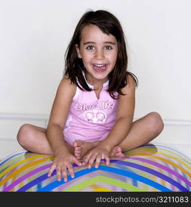 Portrait of a girl sitting on an inflatable ball