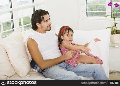 Portrait of a girl sitting on her father&acute;s lap