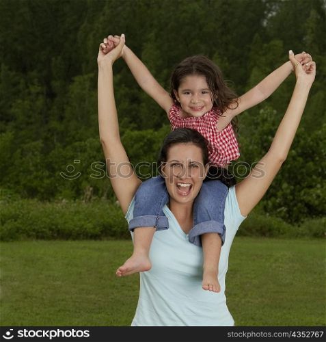 Portrait of a girl sitting on her mother&acute;s shoulders