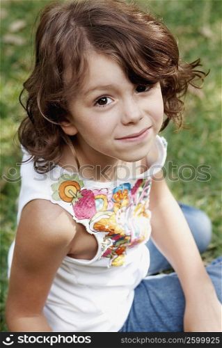 Portrait of a girl sitting on the grass