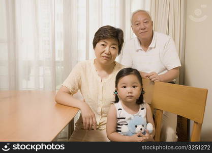 Portrait of a girl sitting with her grandparents