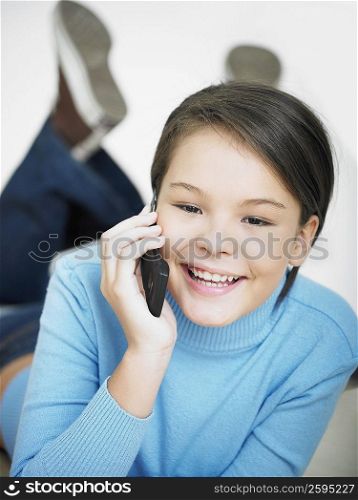 Portrait of a girl smiling and holding a mobile phone