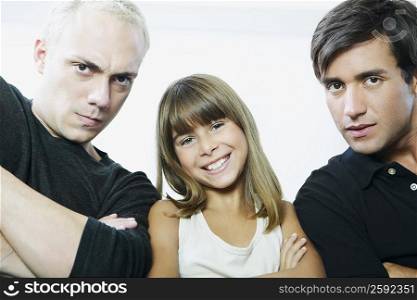 Portrait of a girl smiling between two young men