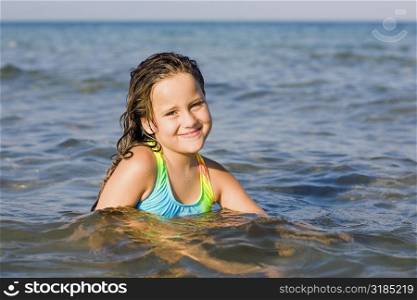 Portrait of a girl smiling in the sea